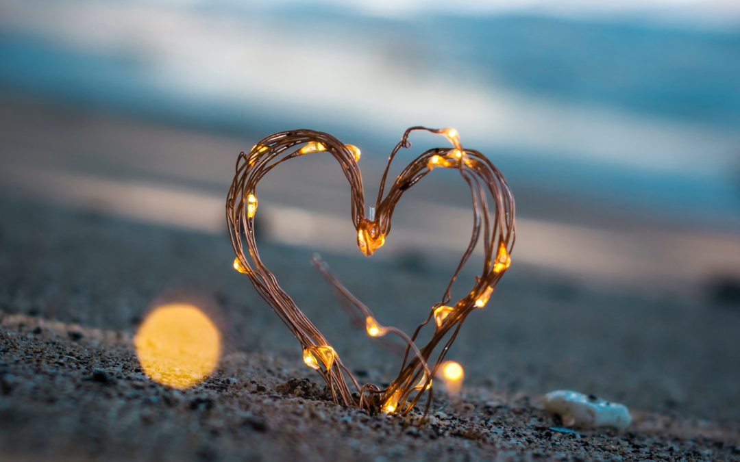 heart with lights in sand