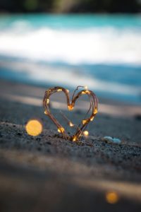 heart with lights in sand